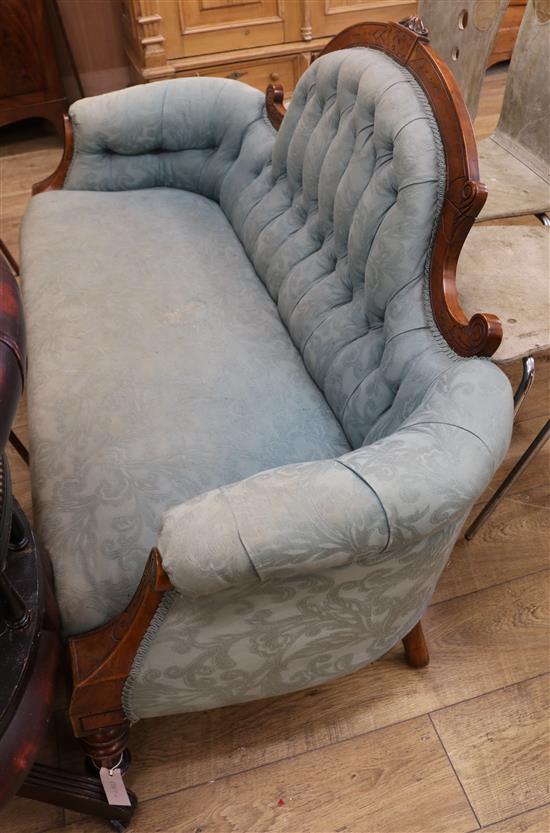A late Victorian carved walnut upholstered settee W.158cm